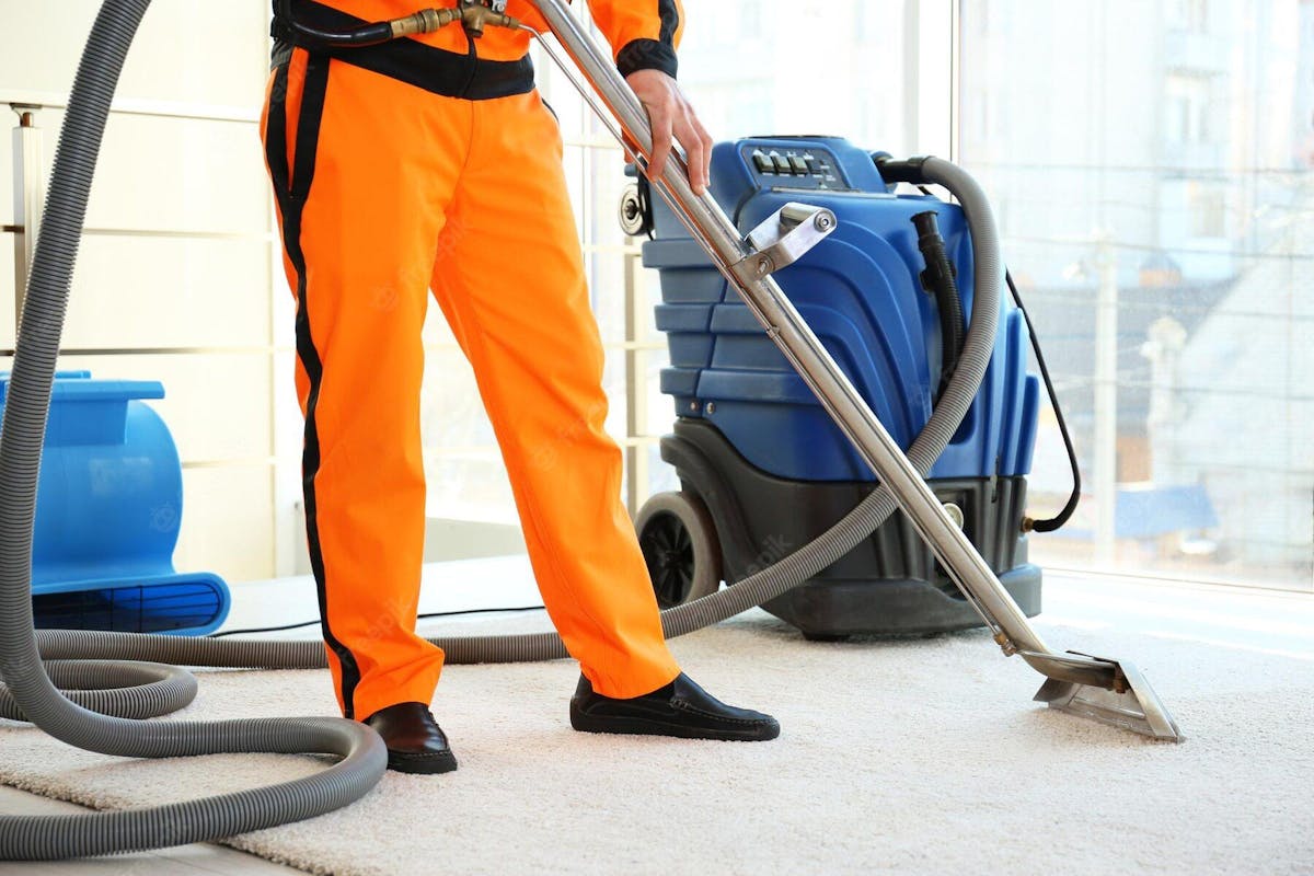 man cleaning carpets with machine