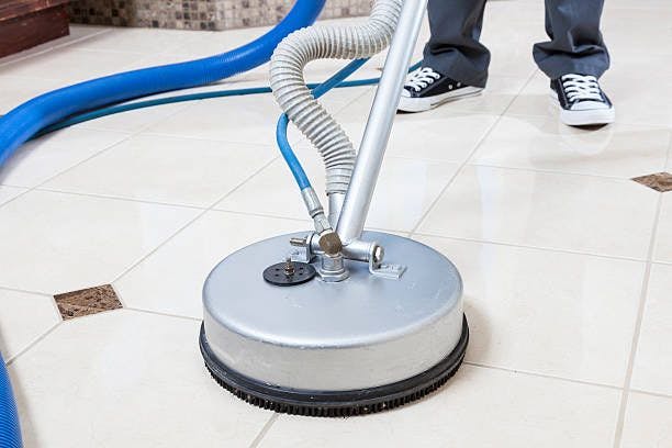 person using machine to clean tile and grout